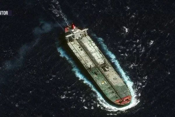 U.S. seizure of tanker near Venezuela, large oil ship stopped at sea with U.S. patrol vessel in the distance, symbolizing blocked Venezuelan oil exports.