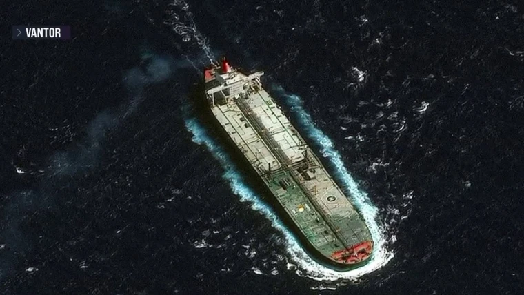 U.S. seizure of tanker near Venezuela, large oil ship stopped at sea with U.S. patrol vessel in the distance, symbolizing blocked Venezuelan oil exports.